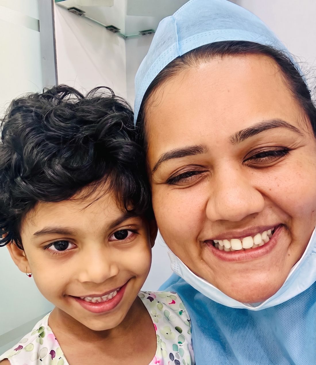 Dr. Shraddha smiling with an older child patient at the clinic